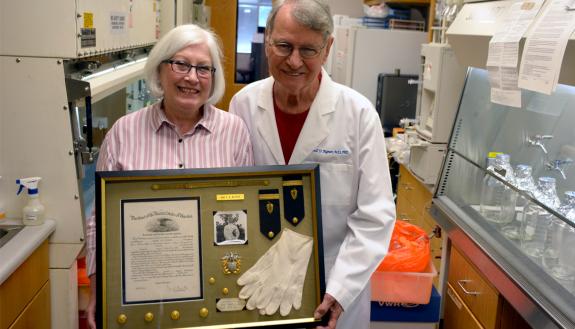 Rita and Darell Bigner used a discount from Bull City Art & Frame for memorabilia from Darell’s service in the Navy Medical Corps. Photo by Jonathan Black.