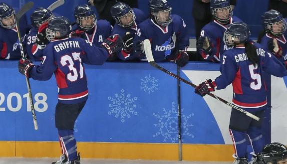 Randi Griffin, left, celebrates her goal against Japan in the Winter Olympics with teammates on the Korean women's ice hockey team. Photo courtesy of the Korean Ice Hockey Association.