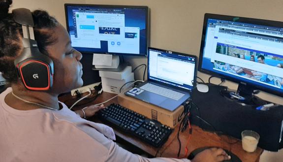 Robby Robinson, a service desk analyst with Duke’s Office of Information Technology, helps Duke community members with computer issues while working from home. Photo courtesy of Robby Robinson.
