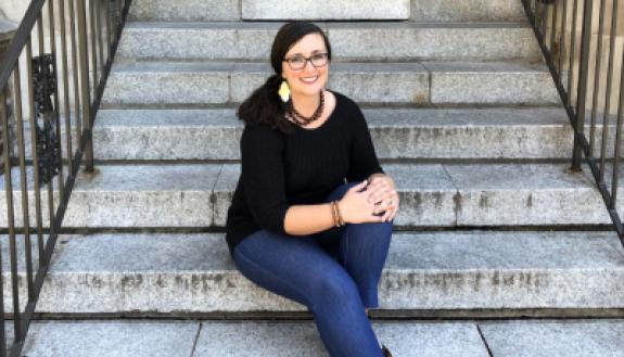 Sarah Gaither sitting on campus steps