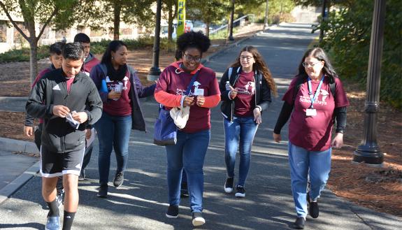 Katryna Robinson, center, with Duke University Libraries, guides Durham Public School students around campus during the 2019 "Duke-Durham School Days." Photo by Jonathan Black.