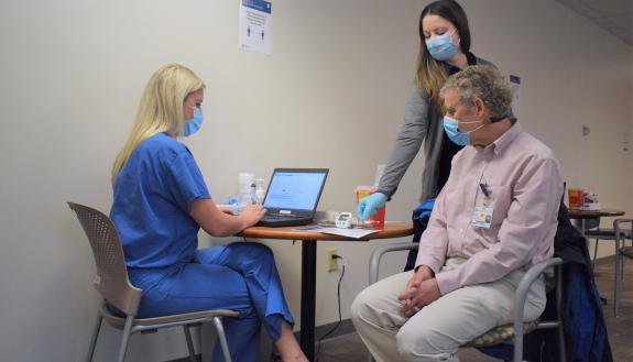 Duke Raleigh Hospital's Scott Gersh receives his first dose of the COVID-19 vaccine in December. Photo by Shawn Rocco.