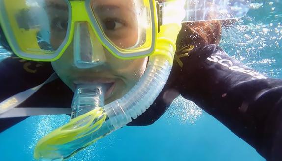Simone Pitre of Duke's Innovations in Healthcare snorkels during #DukeTimeOff in Australia.