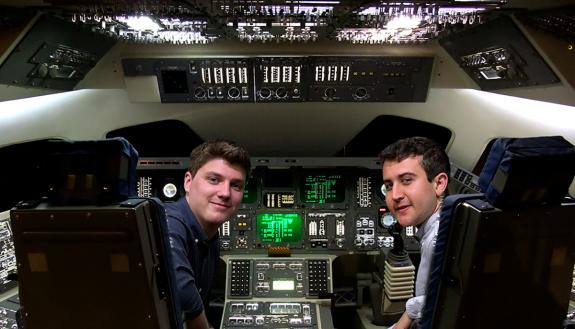 Dominic Tanzillo and Nick Saba in a simulation of a spaceship cockpit