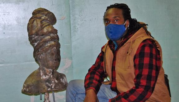 Stephen Hayes, pictured here next to a sculpture project, creates art that speaks to the Black experience. Photo by Jack Frederick.