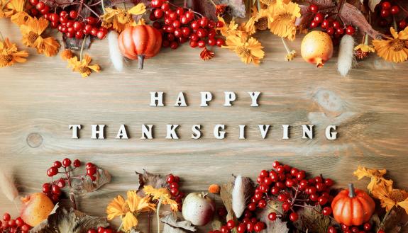 Leaves on top of a Happy Thanksgiving message.