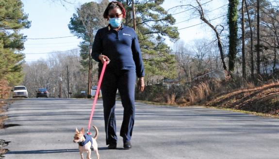 Wanda Amons and her dog, Cola, take a walk near Amons' Durham home. Photo by Stephen Schramm.