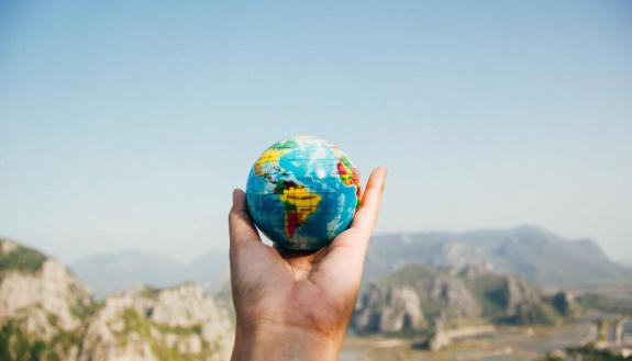 small globe held in a hand