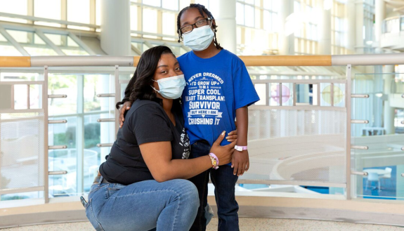 Sharday (left) and Ja'Kye Mason (right) pose together at Duke Hospital.