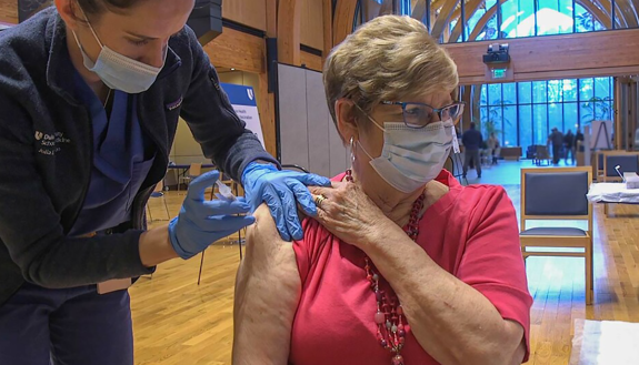 patient receives COVID vaccination in Karsh