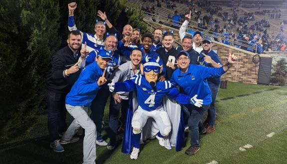 Blue Devil mascots at the reunion join the current mascot on the Wallace Wade Stadium field