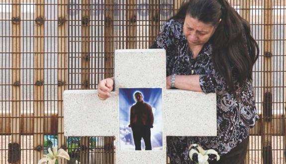 A woman mourns her grandson marking the spot where he was killed by a border agent in 2011.