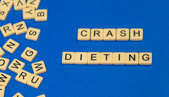 scrabble tiles spelling out crash diet