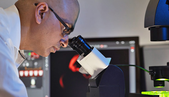 Sandeep Dave, at a microscope