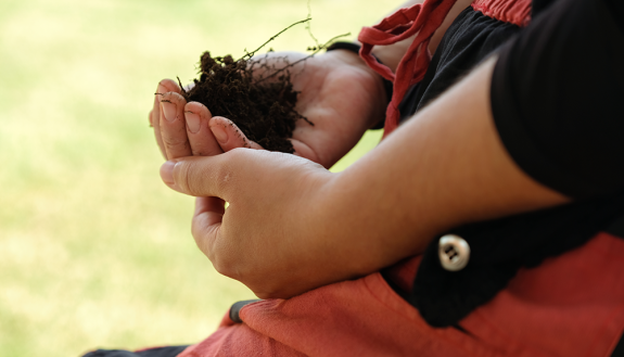 soil from the Duke Campus Farms, being held in hands of researcher