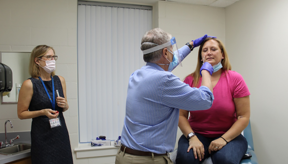 Duke doctors with patient in COVID vaccine research