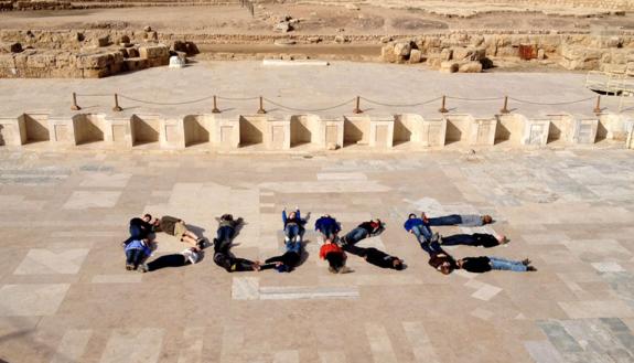 Duke student archeologists spell out "Duke" in the dig site in Ceasaria.