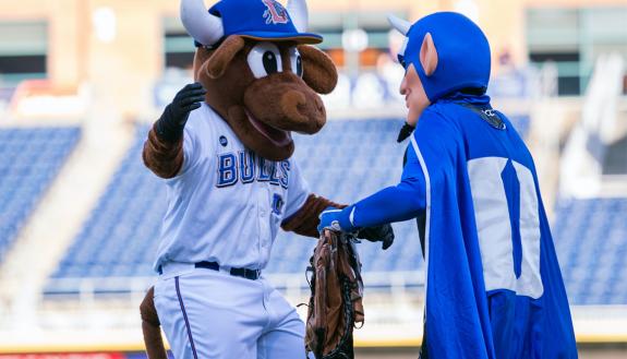 Durham Bulls mascot Wool E. Bull greets the Duke Blue Devil during the two teams' 2017 meeting. Photo courtesy of Duke Athletics.