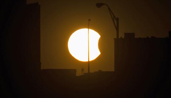 A partial solar eclipse is visible just before sunset Thursday, Oct. 23, 2014, in Arlington, VA. Photo by Bill Ingalls/NASA.