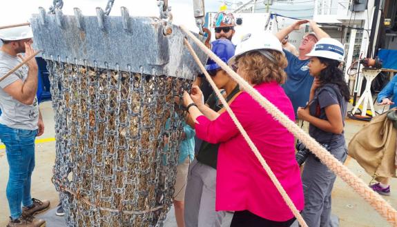 Researcher Emily Klein at sea taking bore samples from the volcanic ocean