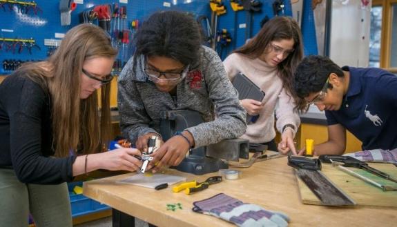 Students working in the Design POD get comfortable with basic shop tools