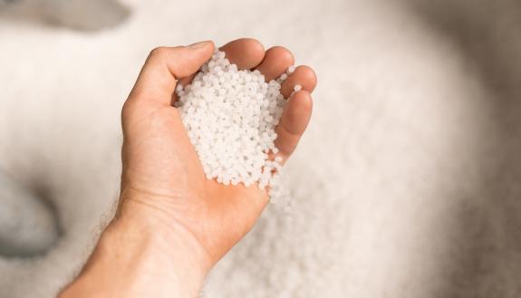 stock image of hand holding sugar at industrial factory