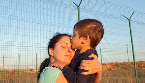 migrant family hugging