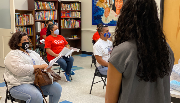 Members of LATIN-19 share information with local residents.