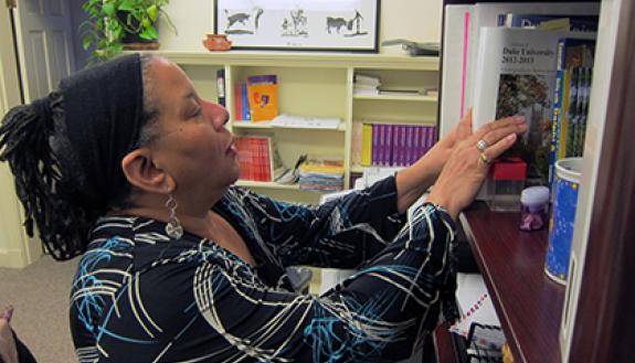Pat McPherson arranges items on a bookshelf in her office. It features personal items as well as books and information for the variety of responsibilities she holds. "I serve many people, doing something for everyone," she said.