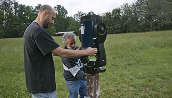 From left to right, Duke Physics lab manager Yuriy Bomze and physics professor Ronen Plesser adjust a Meade LX200GPS Schmidt-Cassegrain telescope. Photo by Duke Photography 