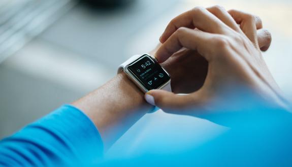 stock image of man using smart watch