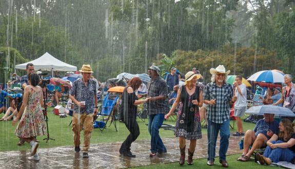 dancers in the rain at Terrance Simien and the Zydeco Experience