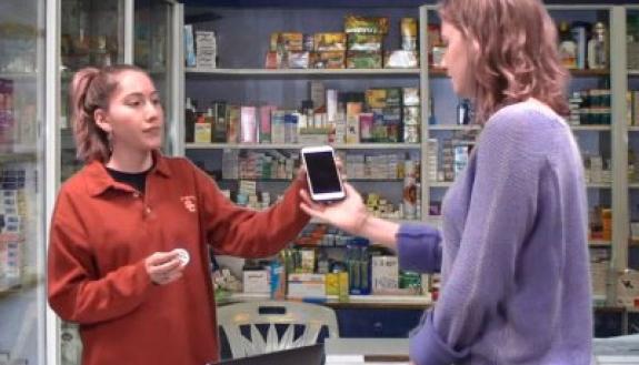 In one of the videos, students demonstrate how to request translation services at a pharmacy.
