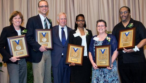 Posing with President Richard H. Brodhead (center) are 2016 Presidential Award recipients (left to right) Tracy Futhey, Richard Outten, Lakeshia “Kiwi” Whitted, Jean Hartford-Todd and Oliver “Ollie” Miller. 