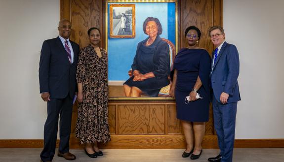 The Reuben-Cooke family with President Vincent Price in front of the portrait of Wilhelmina Reuben-Cooke.