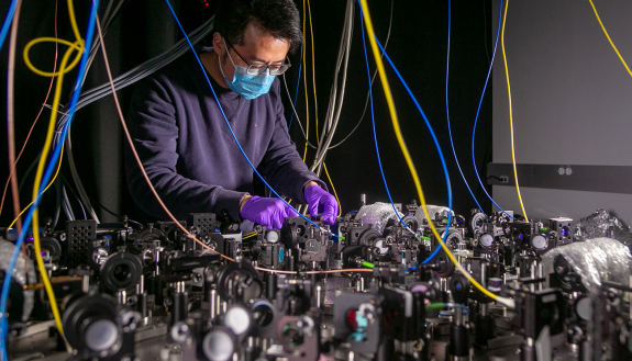  Lu Qi, an Electrical and Computer Engineering Postdoctoral Fellow in the Brown Lab works on a quantum computer setup.