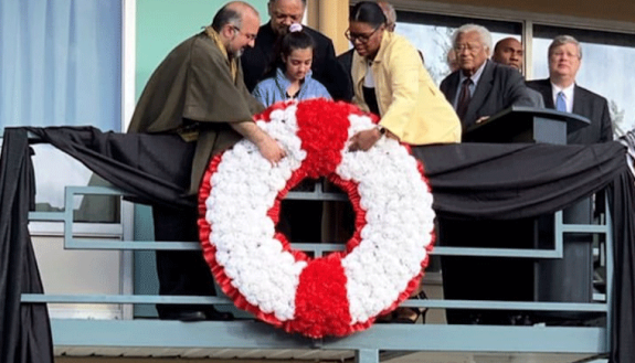 Professor Omid Safi helps place a wreath on the balcony outside of where Rev. Martin Luther King Jr. was assassinated in Memphis.