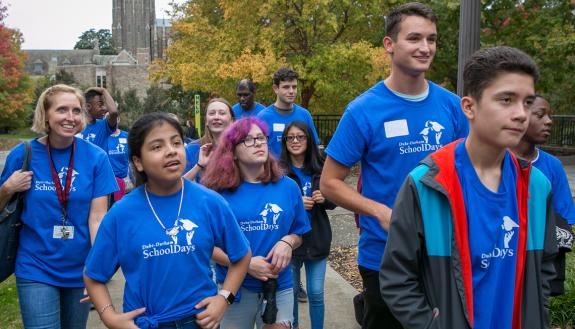 Duke senior Dillon Leovic, right, takes an eighth grade classroom from Little River K-8 on a tour of campus during Duke-Durham School Days. Photo by Jared Lazarus.