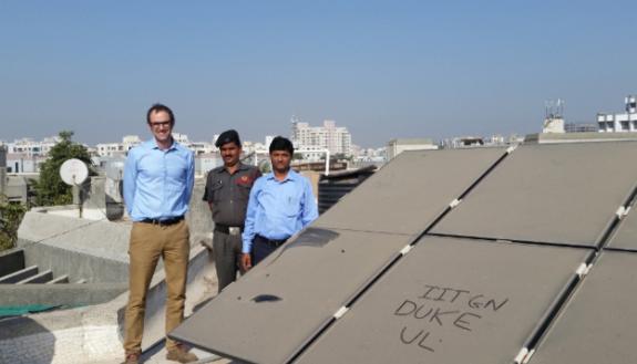 Duke engineering professor Michael Bergin (left) stands with Indian Institute of Technology-Gandhinagar colleague Chinmay Ghoroi (right) next to that university’s extremely dusty solar panel array.