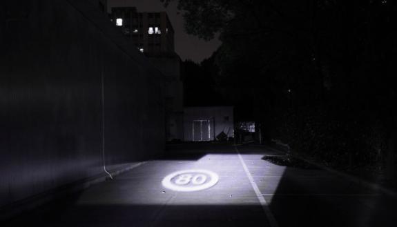 ECE Professor Xin Li is helping HASCO Vision Technology create 'smart headlights' that can display information within the beam such as the directions shown on the roadway here.