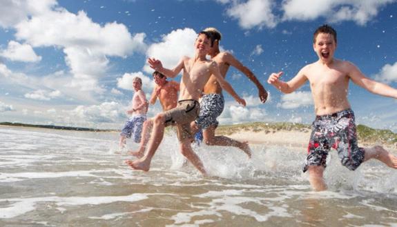 boys running into water