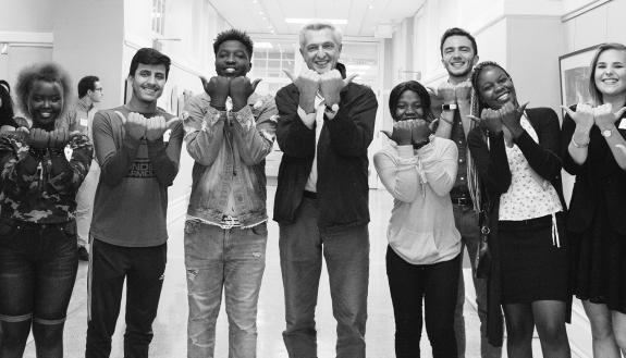UN refugee commissioner Filippo Grandi (middle) meets with Durham mayor Steve Schewel and Kenan students at photo exhibit.