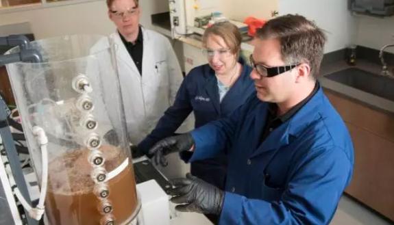 Researchers Brian Hawkins, Katelyn Sellgren and James Thostenson work together at the Center for WaSH-AID.