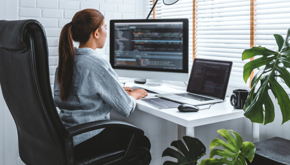 Woman at desk working at a desk with correct posture