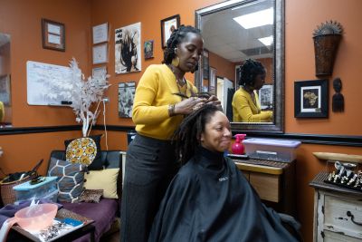 Aliaha Austin, graduate student at the Sanford School of Public Policy, gets her hair styled by Jeunesse (Jey) Hall, stylist and owner of Natural Roots by Jey on University Drive in Durham.