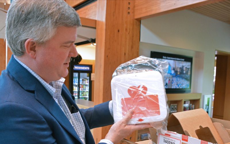 Matthew Stiegel holds an AED.
