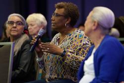 An audience member asks the panel a question